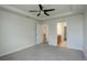 A spacious bedroom with a ceiling fan and view to an attached bathroom at 2200 S University Blvd # 313, Denver, CO 80210