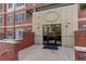 Exterior entrance of the building featuring brick and stone accents with glass doors at 2200 S University Blvd # 313, Denver, CO 80210