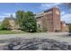 Brick buildings with lush green trees and lawns on a sunny day at 2200 S University Blvd # 313, Denver, CO 80210