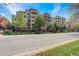 Exterior view of the apartment building with balconies and mature trees along the street at 2200 S University Blvd # 313, Denver, CO 80210