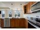 This kitchen features stainless steel appliances, granite countertops, and wooden cabinetry at 2200 S University Blvd # 313, Denver, CO 80210