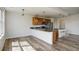 Spacious kitchen flows into living space with ample counter seating and stainless appliances at 2200 S University Blvd # 313, Denver, CO 80210