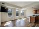 Sun-filled living room with large windows, wood flooring, and modern lighting fixtures at 2200 S University Blvd # 313, Denver, CO 80210