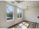 Well-lit living area with large windows, modern light fixture, and wood-look flooring at 2200 S University Blvd # 313, Denver, CO 80210