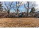 Spacious backyard with bare trees, partially fenced-in, offering privacy and room for outdoor activities at 6066 S Monaco Way, Centennial, CO 80111