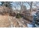 Landscaped backyard area showcasing mature trees, rock features, and a wooden fence, offering privacy at 6066 S Monaco Way, Centennial, CO 80111