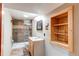 Bathroom showcasing a stylish vanity, decorative shelving, and tiled shower at 6066 S Monaco Way, Centennial, CO 80111