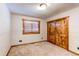 Cozy bedroom with carpet, wood trim window, and sliding wood closet doors at 6066 S Monaco Way, Centennial, CO 80111