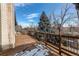 Exterior deck with a railing featuring a scenic mountain forest design at 6066 S Monaco Way, Centennial, CO 80111