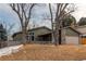 A lovely home featuring stone accents and a well-maintained yard with mature trees at 6066 S Monaco Way, Centennial, CO 80111