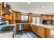 Beautiful kitchen with stainless steel appliances, wooden cabinets, and quartz countertops at 6066 S Monaco Way, Centennial, CO 80111