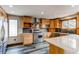 Well-lit kitchen with stainless steel appliances, wooden cabinets, and modern countertops at 6066 S Monaco Way, Centennial, CO 80111