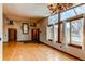 Bright living room featuring large windows and a decorative antler chandelier at 6066 S Monaco Way, Centennial, CO 80111