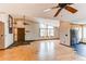 Open-concept living space with a vaulted ceiling, wood floors, and natural light at 6066 S Monaco Way, Centennial, CO 80111