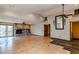 Spacious living room featuring a stone fireplace, wood floors, and natural light from french doors at 6066 S Monaco Way, Centennial, CO 80111