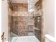 Modern shower featuring stylish tile, glass enclosure, and sleek fixtures, enhancing this bathroom at 6066 S Monaco Way, Centennial, CO 80111