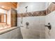 Bathroom tile shower featuring glass partition and mounted fixtures at 6066 S Monaco Way, Centennial, CO 80111