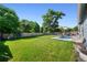 Expansive backyard with lush green grass, patio, and privacy fence at 6074 S Dudley Way, Littleton, CO 80123