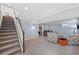 Finished basement with carpeted stairs leading down to the room and comfortable seating at 6074 S Dudley Way, Littleton, CO 80123