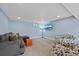 Finished basement with a flat screen television, comfortable seating, and neutral carpet at 6074 S Dudley Way, Littleton, CO 80123