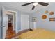 Neutral bedroom with ceiling fan, closet, dresser, and decor on the walls at 6074 S Dudley Way, Littleton, CO 80123