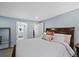 Bright bedroom offers a comfortable bed and access to an ensuite bathroom and walk-in closet at 6074 S Dudley Way, Littleton, CO 80123