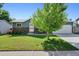 Charming single-story home with a well-manicured lawn, stone accents, and mature trees in a desirable neighborhood at 6074 S Dudley Way, Littleton, CO 80123