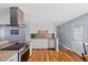 Bright kitchen features stainless steel appliances, white cabinets, and granite countertops at 6074 S Dudley Way, Littleton, CO 80123