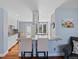Open living space featuring a breakfast bar with seating, hardwood floors, and neutral paint at 6074 S Dudley Way, Littleton, CO 80123
