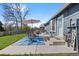 Charming patio area with a table set, an umbrella, and a concrete foundation adjacent to the house at 6074 S Dudley Way, Littleton, CO 80123