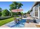 Comfortable patio seating area, perfect for relaxing and enjoying the backyard, complete with umbrella at 6074 S Dudley Way, Littleton, CO 80123