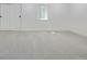 Finished basement with neutral carpet and clean white walls, and a window at 5951 S Akron Way, Greenwood Village, CO 80111
