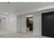 Finished basement with gray carpet, adjacent bathroom, and contrasting black doors at 5951 S Akron Way, Greenwood Village, CO 80111