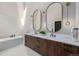 Elegant bathroom with double vanity, modern lighting, and a freestanding tub at 5951 S Akron Way, Greenwood Village, CO 80111