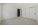 Well-lit bedroom offers neutral carpeting, and a modern closet with clean design that maximizes space at 5951 S Akron Way, Greenwood Village, CO 80111