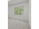 Bright bedroom features a large window providing natural light at 5951 S Akron Way, Greenwood Village, CO 80111