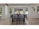 Bright breakfast nook featuring a round table, cozy chairs, bay windows, and a view of the backyard at 5951 S Akron Way, Greenwood Village, CO 80111