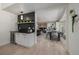 Open-concept dining area features a wine bar, modern decor, and light hardwood floors at 5951 S Akron Way, Greenwood Village, CO 80111