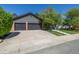 Charming home exterior with a three-car garage and concrete driveway at 5951 S Akron Way, Greenwood Village, CO 80111
