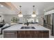 Bright kitchen island with seating and an open view into the breakfast nook area with backyard views at 5951 S Akron Way, Greenwood Village, CO 80111