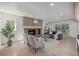 Sun-filled living room features stone fireplace, neutral furniture, and sliding glass door to backyard at 5951 S Akron Way, Greenwood Village, CO 80111