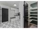 Stylish mudroom with white cabinetry, patterned flooring, and a built-in bench with storage solutions at 5951 S Akron Way, Greenwood Village, CO 80111