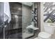 Stylish tiled shower with a glass door and decorative accents at 5951 S Akron Way, Greenwood Village, CO 80111