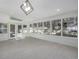Bright sunroom with multiple windows, tiled floor, and modern light fixture at 5951 S Akron Way, Greenwood Village, CO 80111