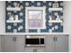 Close-up of a kitchen featuring custom backsplash, floating shelves, and stainless steel microwave at 2675 Kearney St, Denver, CO 80207