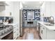 Modern kitchen with stainless steel appliances, white cabinets, and unique backsplash at 2675 Kearney St, Denver, CO 80207