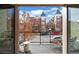 Balcony with seating, great views of a tree-lined street and neighborhood buildings under a sunny sky at 32 Jackson St, Denver, CO 80206