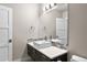 Bathroom featuring a modern square sink, dark vanity, and a decorative mirror at 32 Jackson St, Denver, CO 80206