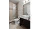 Bathroom featuring a walk-in shower, modern fixtures, and a floating vanity at 32 Jackson St, Denver, CO 80206