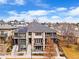 Beautiful townhouse featuring a gray roof, brick facade, and balconies in a vibrant neighborhood with blue skies at 32 Jackson St, Denver, CO 80206
